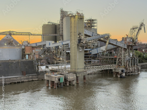 Old grain terminal at seaport with loading conveyor and silos 1