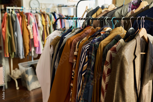 Tableau sur toile Clothing rack displaying assorted vintage garments hanging in thrift shop, vario