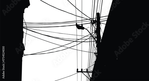 Urban electric pole silhouette with tangled wires, streetlight, and power cables between buildings, black and white vector illustration for electricity infrastructure design