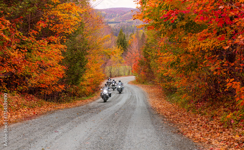 Motorcycles driving along an autumn country road, Wakefield, Quebec, Canada 
