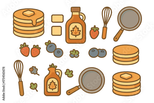 Stacks of pancakes with maple syrup, butter, and berries alongside kitchen tools