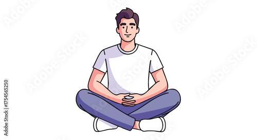 A young man with short dark hair and a white t-shirt sits cross-legged with his hands clasped in his lap, looking directly at the viewer with a slight smile.