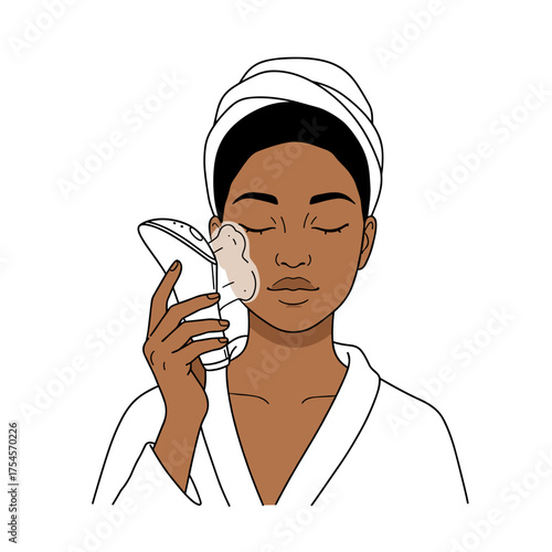 A young black woman uses a facial steamer at home