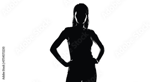 Silhouette of a woman in athletic wear standing with hands on hips