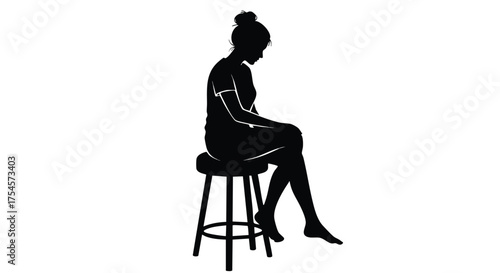Silhouette of a woman sitting on a stool looking down thoughtfully