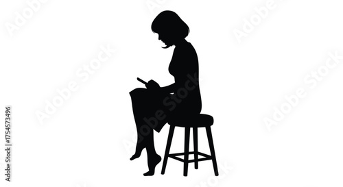 Silhouette of a young woman sitting on a stool, engrossed in her phone with her legs crossed, a moment of quiet contemplation in a minimalist setting