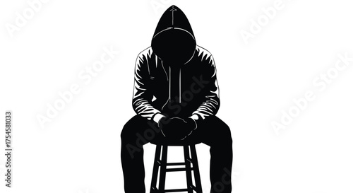 Anonymous hooded figure sitting on a stool in a silhouette with their head down