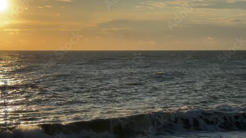 sunset at sea. sea waves in the rays of the setting sun.