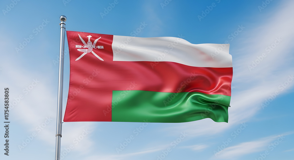 Naklejka premium Oman's National Flag Waving Majestically Against a Bright Blue Sky with Wispy Clouds