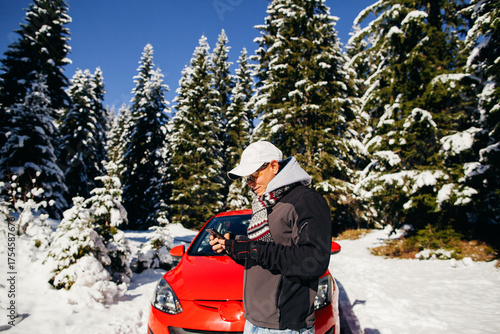 man travel by car in mountains winter time. Man using rental car for travel in winter snow forest