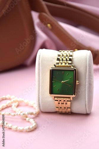 Closeup minimal fashion wristwatch for women on pink background.