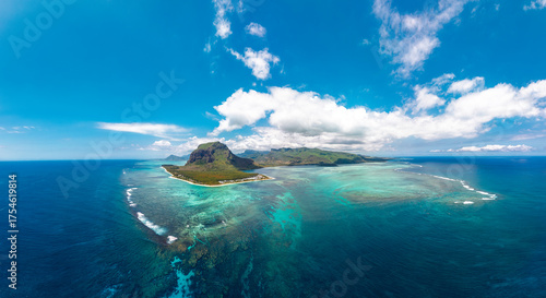 Le Morne Brabant Mauritius aerial panorama of turquoise lagoon coral reef surf lines and deep blue ocean sky