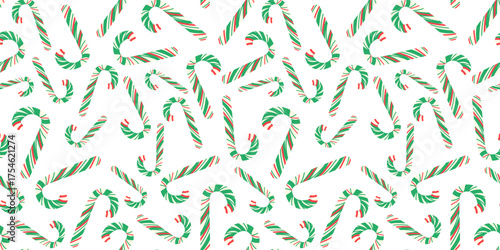 Festive, traditional seamless vector pattern featuring a scattered, all-over design of classic red, white and green striped candy canes.