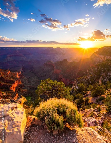 Canyon landscape at sunset, sunbeams highlight the red rocks and vastness