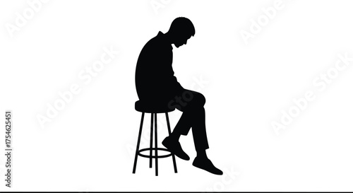 Silhouette of a man sitting on a stool with his head bowed, conveying a sense of contemplation or sadness
