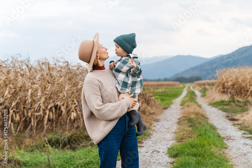 Photos Mother and son walking playing together in agricultural field area