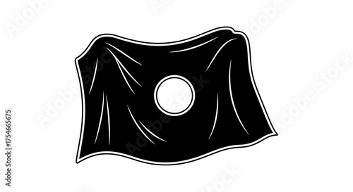Black fabric draped over a circular object with a hole in the center.