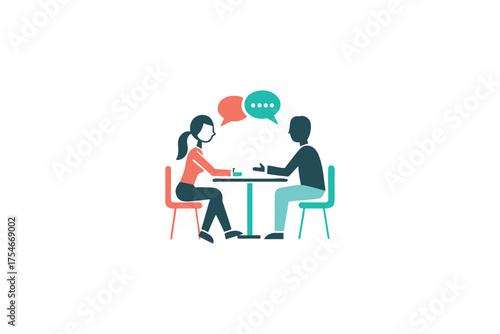 Two people are having a conversation while seated at a table