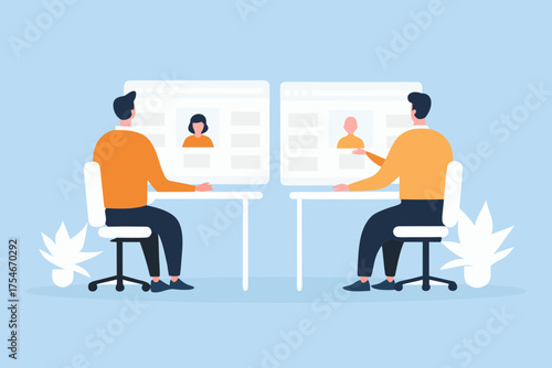 Two people sitting at desks reviewing online profiles on computer screens during a meeting or interview
