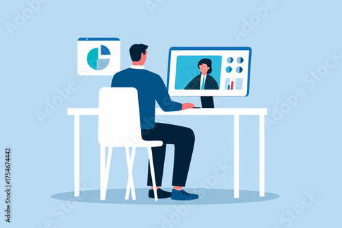 Man in suit having a video conference call with a colleague while working at his desk with charts