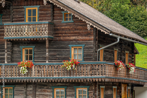 Traditional alpine wooden house with carved balconies
