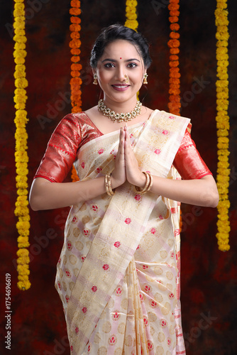 Beautiful Indian women with folding hands called Namste Indian welcome Pose with smile and indian costume like saree on the festival occasion. 