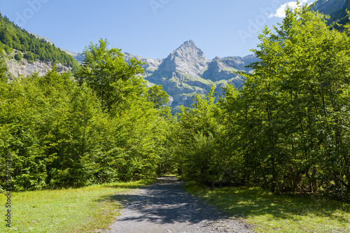 This landscape photo was taken in Europe, France, Auvergne-Rhone-Alpes, Haute-Savoie, Sixt-Fer-a-Cheval, in summer. It shows the hiking trail in the mountains of the Cirque du Fer-a-Cheval