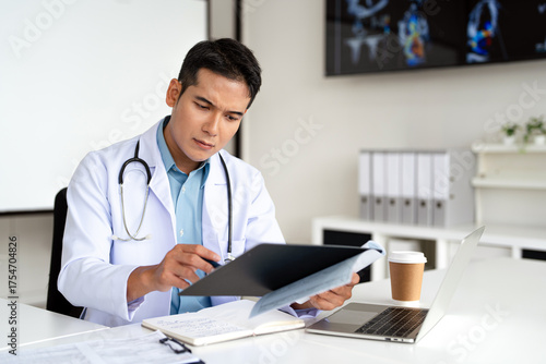 Wallpaper Mural Serious  doctor  working in office,  reading medical document, focused senior therapist physician  wearing doctor gown sitting at desk in hospital, analyzing patient diagnosis or report. Torontodigital.ca
