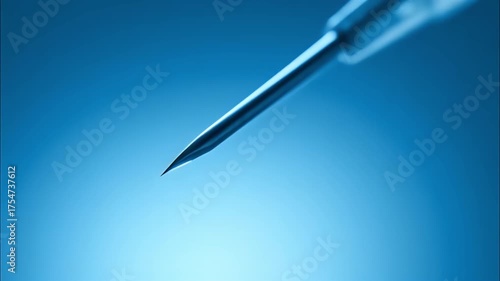 Sterile syringe needle close up with blue medical droplet and clear liquid pipette tip reflecting light, healthcare precision, laboratory sterile drop and calm scientific atmosphere