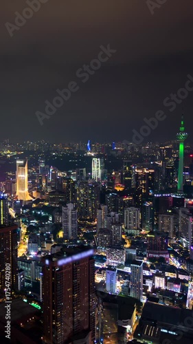 Wallpaper Mural Aerial night timelapse of Kuala Lumpur city with illuminated skyscrapers, glowing skyline, and modern urban lights showcasing the vibrant atmosphere of Malaysia's capital. Torontodigital.ca