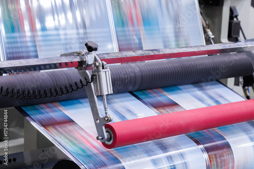 new innovative technology of automatic label printing machine with digital control panel. printing on continuous plastic film for wrapping on food product packaging in the printing factory.