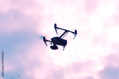 Professional drone shilquotte flying from sky