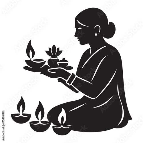 Silhouette of a woman performing a hindu prayer ritual with diyas and offerings