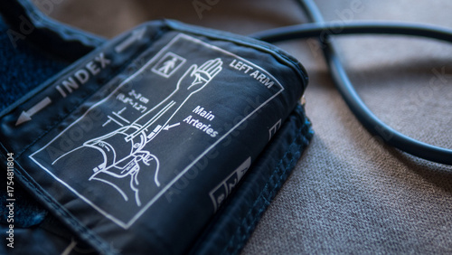 Close-up of a blood pressure cuff with anatomical diagram and labeled instructions for measuring blood pressure on the left arm.