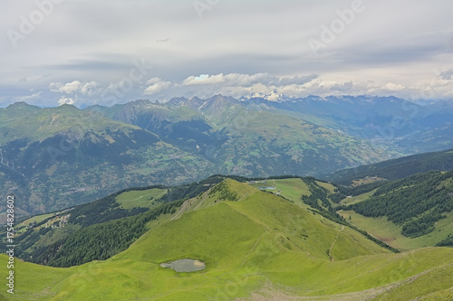 green mountain landscape under a cloudy sky in La Vanoise nature reserve, Savoie, France
