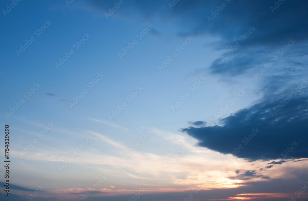Fototapeta premium Dramatic Blue Sky with Dark Clouds and Subtle Sunset, Evening Skyscape, Contrast of Light and Shadow, Tranquil Yet Moody Atmosphere, Natural Beauty, Expansive Horizon, Inspiring Outdoor Scene