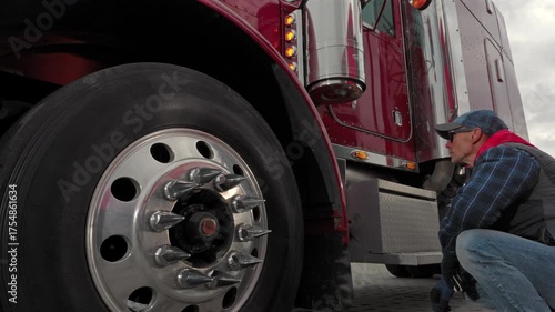 Inspection of a Large Red Truck at a Service Area