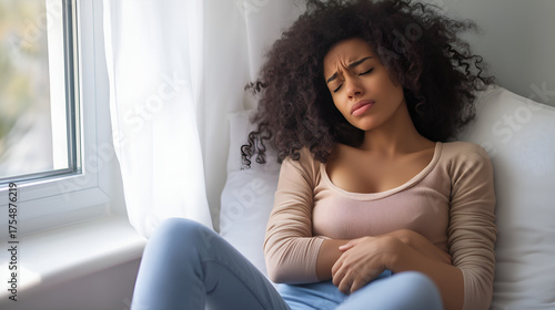 Woman Sitting By Window Holding Stomach In Pain – Realistic Concept Of Abdominal Discomfort, Menstrual Cramps, Or Digestive Illness Free Download Woman Sitting By Window Holding Stomach In Pain – Realistic Concept Of Abdominal Discomfort, Menstrual Cramps, Or Digestive Illness - GFXLoad