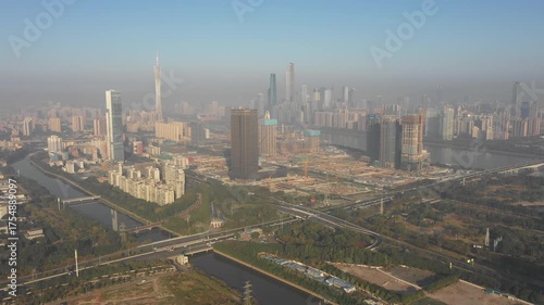 Panoramic drone flight towards massive construction site and city center of Guangzhou in China

