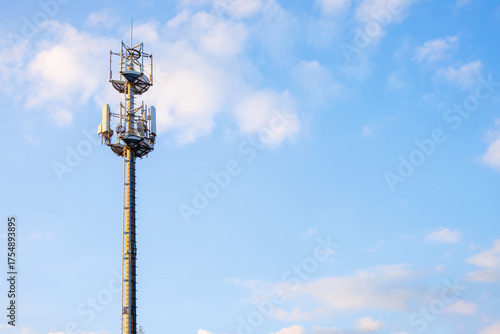 Cell tower of 4G and 5G against a blue sky. Antennas for mobile internet communications.