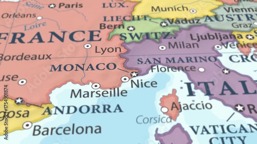 4K macro video of Monaco on a world map with shallow depth of field. Focus on word Monaco and surrounding areas including France, Italy, and the Mediterranean coast. Travel geography footage