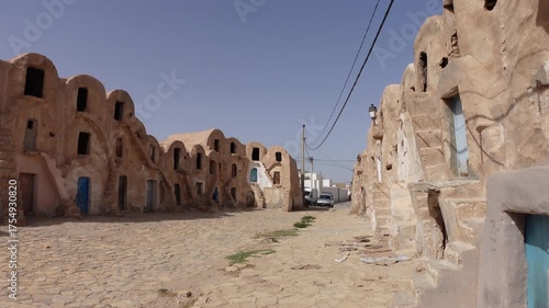 Walking through abandoned historic ksar complex (partly used as a storage facility for the local bazaar) in city of Medenine, Tunisia
