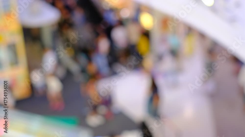 Wallpaper Mural A blurry image of a crowded mall with people walking around. Scene is busy and bustling, with people going about their day Torontodigital.ca