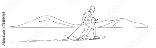 Man skiing in mountains with backpack and ski poles in winter  