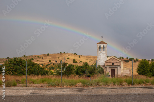 Landscape with the church of Santa Julita and a rainbow in the background in Barcience, Toledo province, Spain