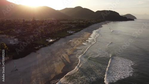 Beautiful sunrise on a tropical paradise beach with small waves in Juquehy