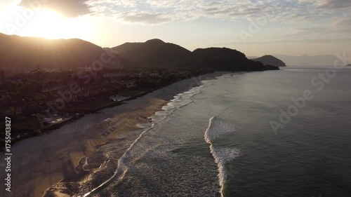 Beautiful sunrise on a tropical paradise beach with small waves in Juquehy