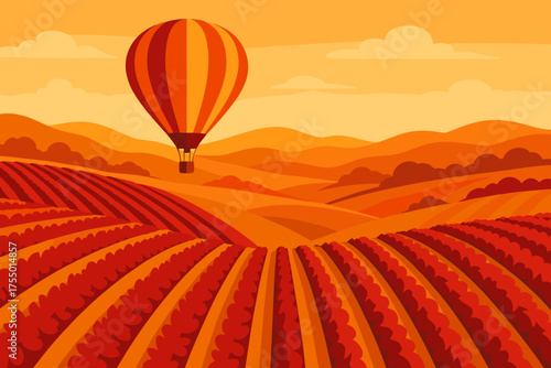 Hot air balloon floats above orange-hued vineyards during sunset in a scenic landscape