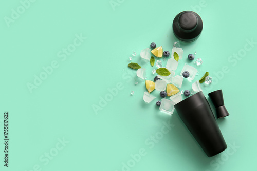 Wallpaper Mural Shaker with measure cup, ice cubes, lime pieces, blueberries and mint leaves on color background Torontodigital.ca