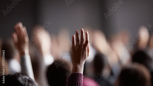Vibrant side view of a multi-ethnic audience attentively seated, numerous hands raised to interact with a speaker after an inspiring master class. Modern venue.